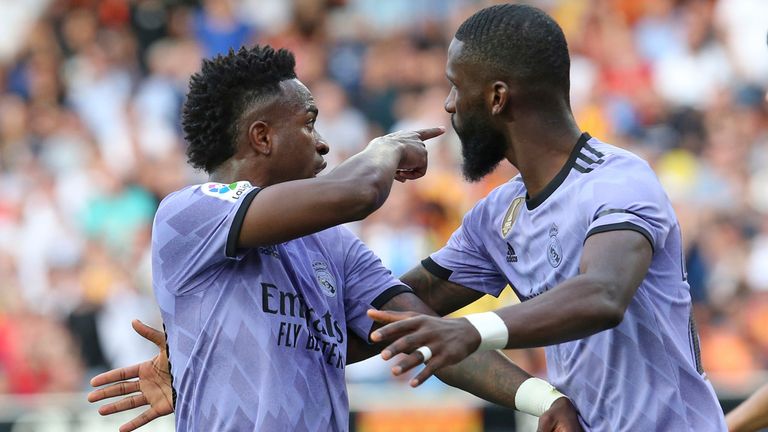 Real Madrid's Vinicius Junior, left, confronts Valencia fans as Antonio Rudiger tries to calm him down during a Spanish La Liga soccer match between Valencia and Real Madrid at the Mestalla stadium in Valencia, Spain, Sunday May 21, 2023 Play was temporarily halted when Vinicius said a fan insulted him from the stands.  He was later sent off after facing Valencia players.  (AP Photo/Alberto Saiz)