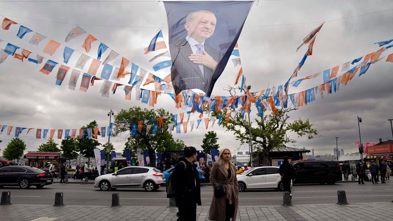 People walk under a picture of Recep Tayyip Erdogan - who has led Turkey since 2014 Pic: AP 