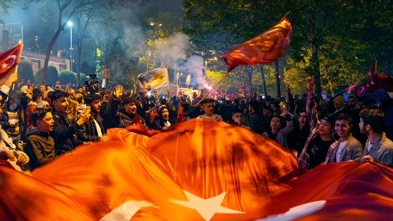 Supporters of President Recep Tayyip Erdogan cheer outside AKP (Justice and Development Party) headquarters in Istanbul, Turkey, Sunday, May 14, 2023. More than 64 million people, including 3.4 million overseas voters, were eligible to vote. (AP Photo/Khalil Hamra)