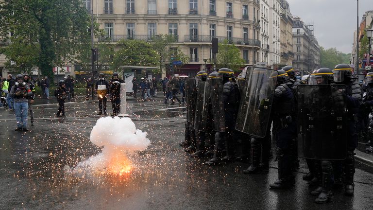 Riot police officers shield from an explosive device during a demonstration, Monday, May 1, 2023 in Paris. Across France, thousands marched in what unions hope are the country&#39;s biggest May Day demonstrations in years, mobilized against President Emmanuel Macron&#39;s recent move to raise the retirement age from 62 to 64. (AP Photo/Thibault Camus)