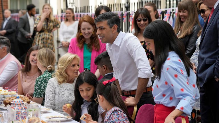 Prime Minister Rishi Sunak gestures as guests including US First Lady Jill Biden, at centre, attend the Big Lunch party at Downing Street in London Sunday, May 7, 2023. The Big Lunch is part of the weekend of celebrations for the Coronation of King Charles III. Guests at the big lunch include community heroes and Ukrainians displaced by the war, and youth groups. Frank Augstein/Pool via REUTERS
