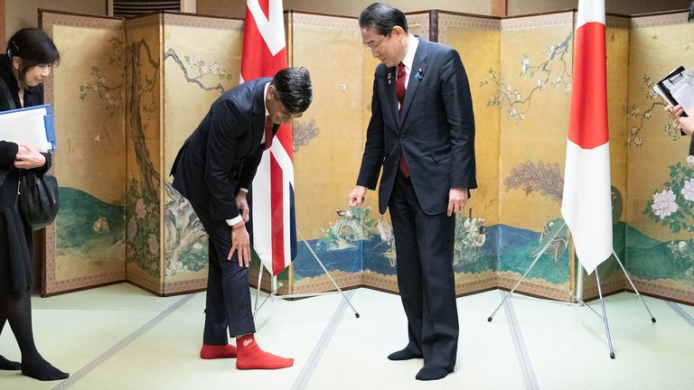 Prime Minister Rishi Sunak shows off his socks to Japanese Prime Minister Fumio Kishida, which has the name of Kishida's favorite baseball team, Hiroshima Toyo Carp, on them, during their bilateral meeting in Hiroshima ahead of the G7 Summit in Japan.  Picture date: Thursday May 18, 2023. PA Photo.  See PA story POLITICS G7.  Photo credit should read: Stefan Rousseau/PA Wire..