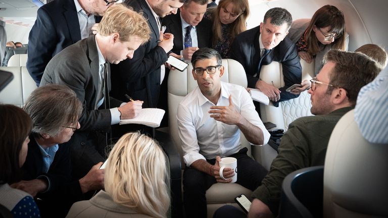 Rishi Sunak holds a huddle with political journalists on board a government plane as he heads to Japan to attend the G7 summit in Hiroshima