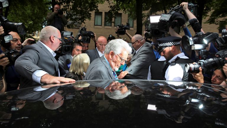 FILE PHOTO: Entertainer Rolf Harris (C) is surrounded by the media as he leaves Southwark Crown Court in London June 30, 2014. Harris, a mainstay of family entertainment in Britain and Australia for more than 50 years, was found guilty on Monday of 12 charges of indecently assaulting young girls over a period of nearly 20 years. REUTERS/Paul Hackett/File Photo
