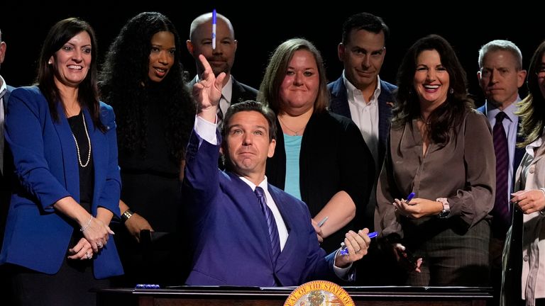 Florida Gov. Ron DeSantis throws markers into the audience after signing various bills during a bill signing ceremony at the Coastal Community Church at Lighthouse Point, Tuesday, May 16, 2023, in Lighthouse Point, Fla. (AP Photo/Wilfredo Lee)