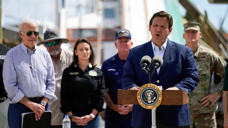 President Joe Biden listens as Florida Gov. Ron DeSantis speaks after they toured an area impacted by Hurricane Ian on Wednesday, Oct. 5, 2022, in Fort Myers Beach, Fla. (AP Photo/Evan Vucci)