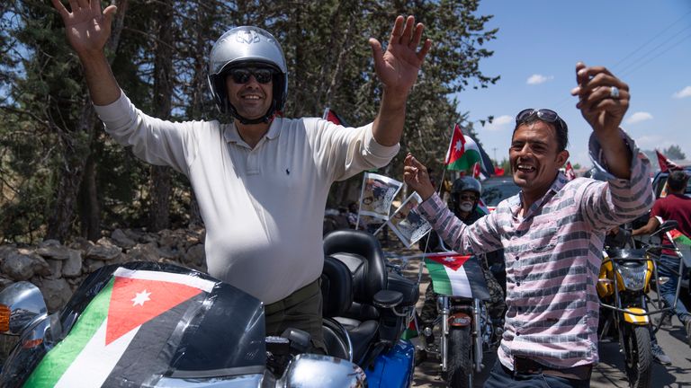 Bikers carrying Jordanian flags dance with traditional songs during a rally celebrating the upcoming royal wedding, in Amman, Jordan, Tuesday, May 30, 2023. Crown Prince Al Hussein and Saudi architect Rajwa Alseif are due to marry on Thursday at a palace wedding in Jordan, a Western-allied monarchy that has been a bastion of stability for decades as unrest in the Middle East battered its borders.  (AP Photo/Nasser Nasser)