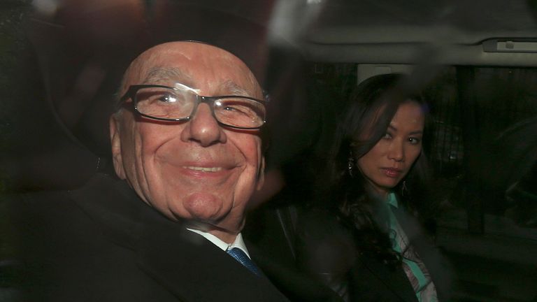 Murdoch, pictured with then-wife Wendi Deng, smiles as he is driven away after giving evidence to the Leveson Inquiry in the High Court in 2012 