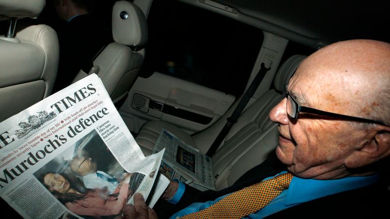 Murdoch seen holding a copy of The Times newspaper in 2011 