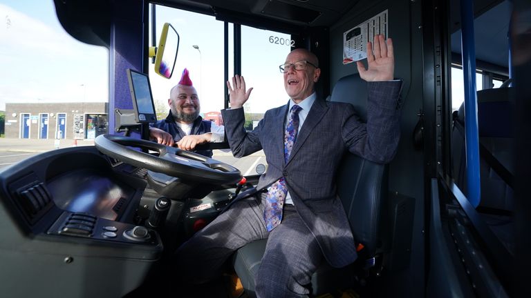Transport Secretary Kevin Stewart (right) and Stuart Deutsch show off a new bus at the Scottish Transport National Control Center in South Queensferry during the launch of the UK's first self-driving bus service. A convoy of five Alexander Dennis Enviro200AV vehicles will travel the 14-mile route across the Forth Road Bridge near Edinburgh in mixed traffic at speeds of up to 50mph. Image date: Thursday, May 11, 2023.