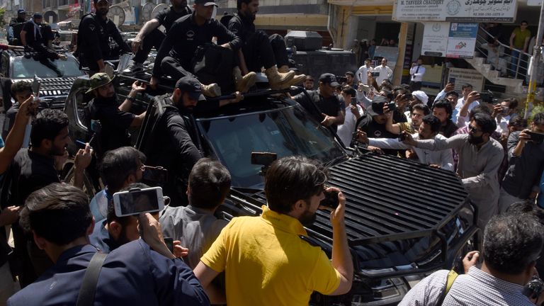 Private security personnel clear the way for a vehicle carrying Pakistan&#39;s former Prime Minister Imran Khan 
Pic:AP