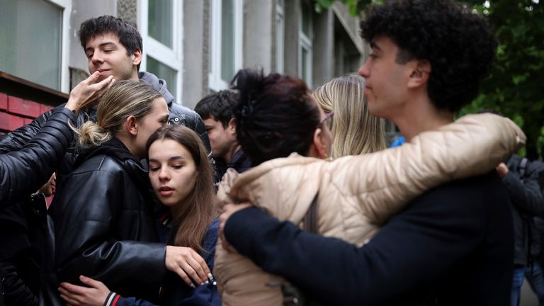 People mourn the victims near Vladislav Ribnikar school in Belgrade, Serbia