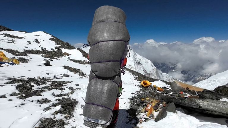 Ngima Tashi Sherpa walks as he carries a Malaysian climber while rescuing him from the death zone above camp four at Everest, Nepal, May 18, 2023 in this screengrab obtained from a handout video. Gelje Sherpa/Handout via REUTERS THIS IMAGE HAS BEEN SUPPLIED BY A THIRD PARTY. MANDATORY CREDIT
