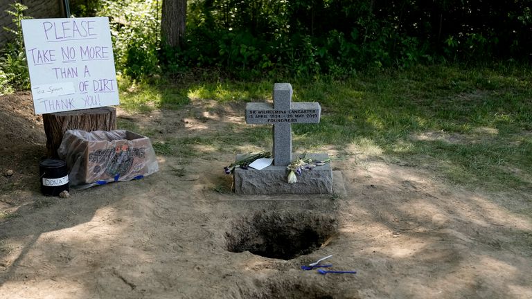 People collect dirt from the gravesite of Sister Wilhelmina Lancaster at the Benedictines of Mary, Queen of Apostles  
Pic:AP