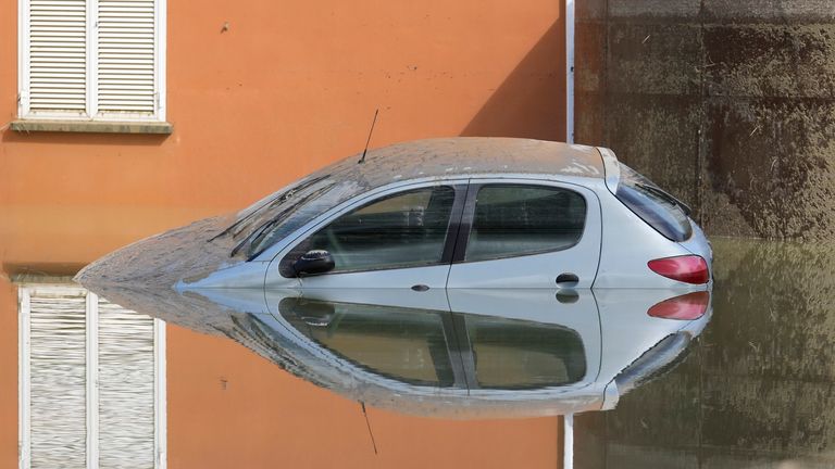 A car is submerged in Faenza, Italy Pic:AP