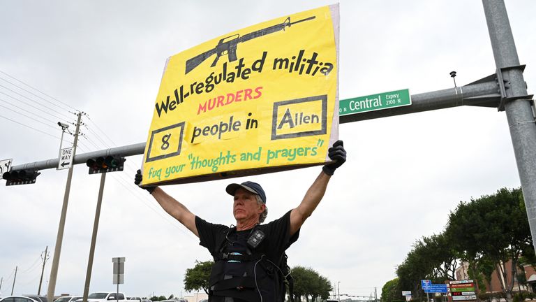 A campaigner for gun control holds up a sign in Allen, Texas
