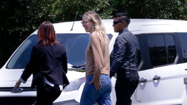Disgraced Theranos CEO Elizabeth Holmes, center, is escorted by prison officials into a federal women...s prison camp on Tuesday, May 30, 2023, in Bryan, Texas. Holmes will spend the next 11 years serving her sentence for overseeing an infamous blood-testing hoax.   (AP Photo/Michael Wyke)