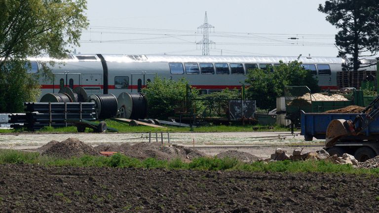 A train stands on the railroad line near the scene of a serious train accident in Huerth, Germany