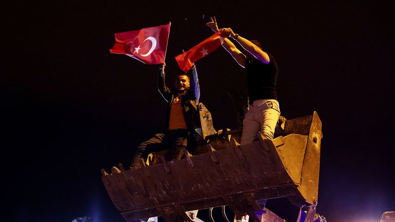 Supporters of Turkish President Tayyip Erdogan celebrate following early exit poll results for the second round of the presidential election in Ankara, Turkey 