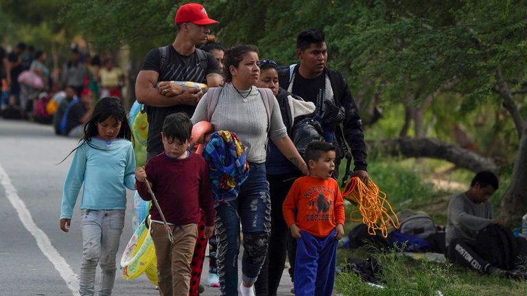 Migrants arrive to the Mexican side of the bank of the Rio Grande river in Matamoros, Mexico. Pic: AP