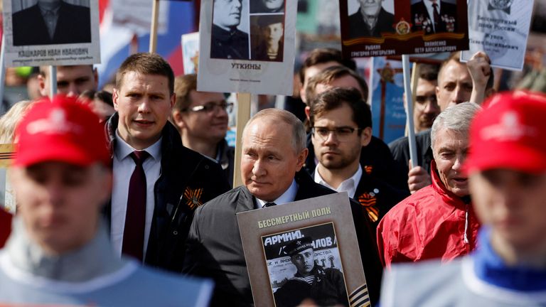 Russian President Vladimir Putin holding a portrait of his father during last year&#39;s Immortal Regiment march on Victory Day
