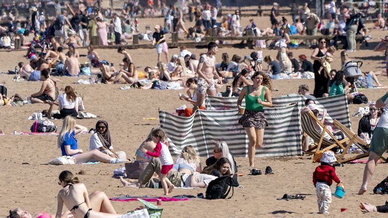People on Portobello Beach, Edinburgh, enjoying the warm weather