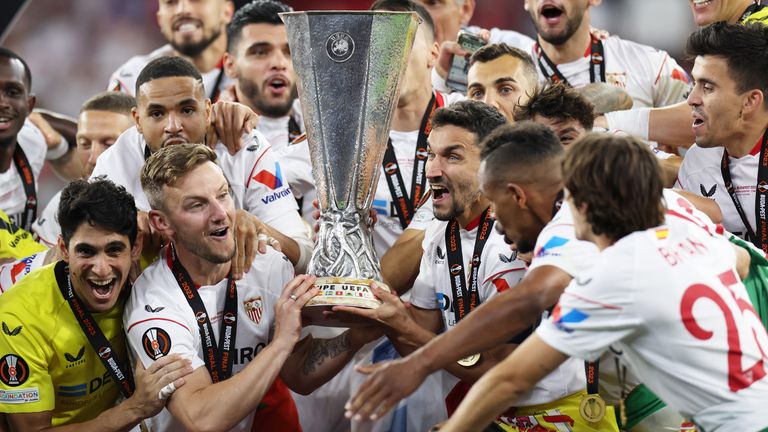 Ivan Rakitic and Jesus Navas of Sevilla lift the UEFA Europa League trophy