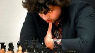 FILE - Chess Grandmaster Hans Niemann, 19, studies the board during a match against Grandmaster Christopher Yoo, 15, at the U.S. Chess Championship in St. Louis on Wednesday, Oct. 5, 2022. Niemann alleges in a federal lawsuit that chess world champion Magnus Carlsen and others destroyed his career by falsely accusing him of cheating.  He is seeking $100 million in damages in the lawsuit filed Thursday, Oct. 20, 2022, in U.S. District Court in St. Louis.  (David Carson/St. Louis Post-Dispatch via AP)