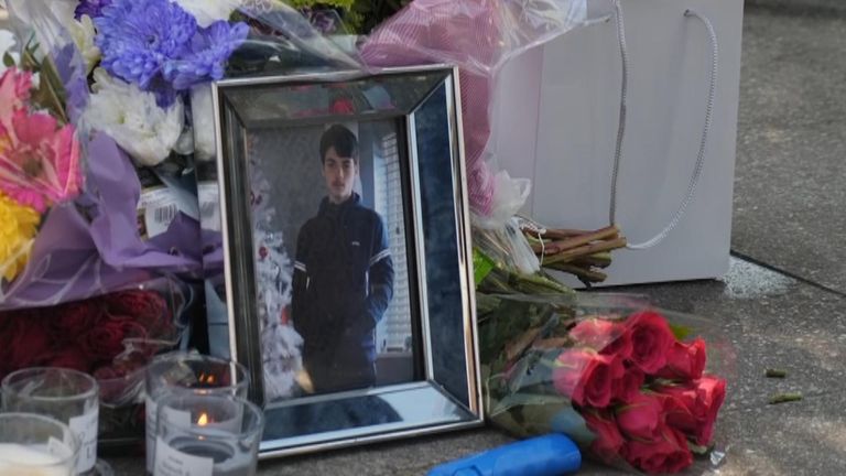 Saul Cookson, a 15-year-old, died in a crash with an ambulance while he was on an e-bike being chased by police. Friends and family paid tribute with flowers and cards at the site of the accident. 