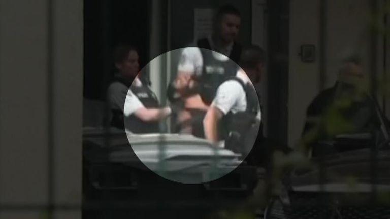 Suspect in Annecy playground stabbings is carried to a police car