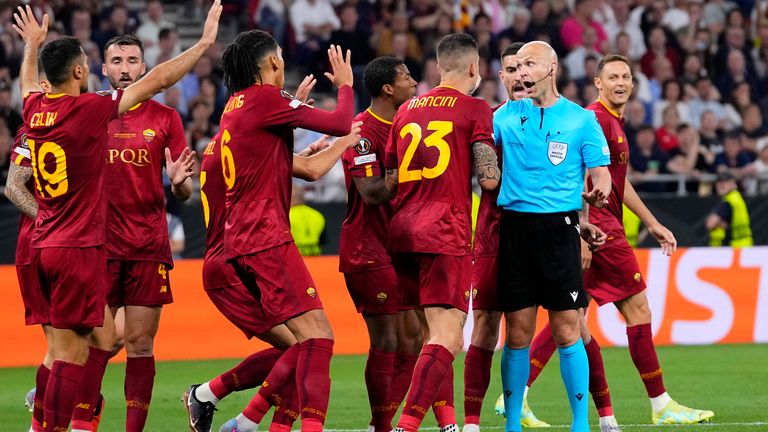 Roma players talk to Referee Anthony Taylor. Pic: AP