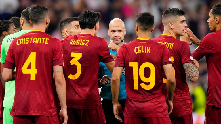 Roma players talk to Referee Anthony Taylor. Pic: AP