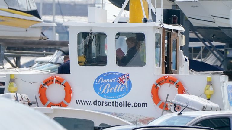 A group of people inspecting the cabin of the Dorset Belle cruise boat which has been impounded at Cobb&#39;s Quay Marine in Poole, Dorset, after a 17-year-old-boy and a girl aged 12 sustained "critical injuries" on Wednesday, and later died in hospital following an incident off Bournemouth beach 