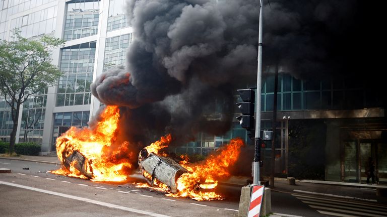 Burning vehicles are seen in a street amid clashes between protesters and police during a march in tribute to Nahel, a 17-year-old teenager killed by a French police officer during a traffic stop, in Nanterre, Paris suburb, France, June 29, 2023. REUTERS/Sarah Meyssonnier
