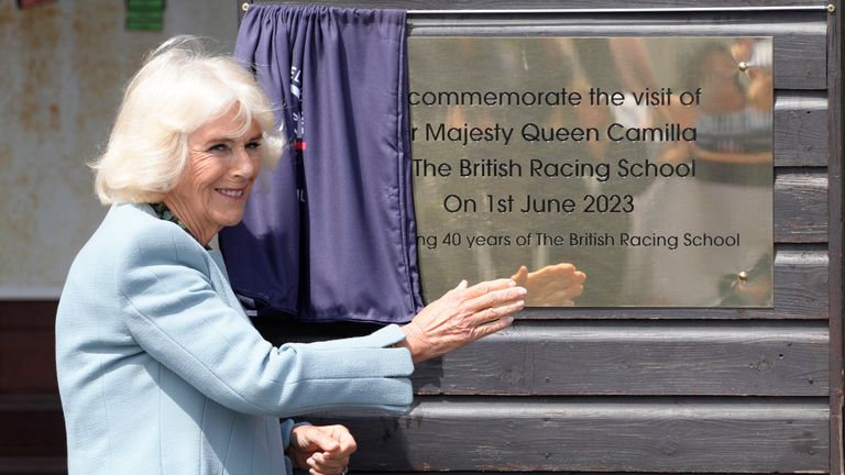 Queen Camilla unveils a plaque during a visit to The British Racing School in Newmarket
Pic:AP