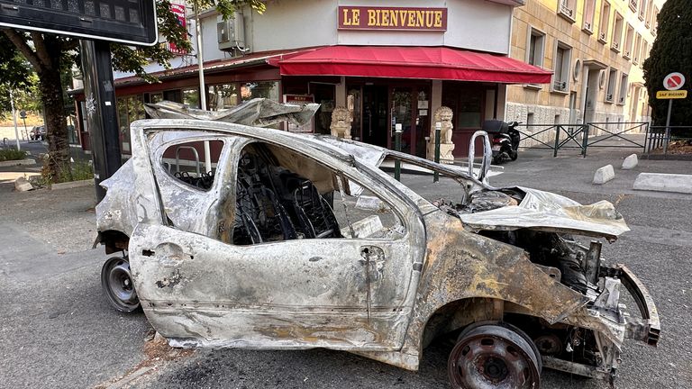 A car, burnt during clashes between youths and police, is seen in a street the day after the death of a 17-year-old teenager killed by a French police officer during a traffic stop, in Nanterre, Paris suburb, France, June 28, 2023. REUTERS/Antony Paone
