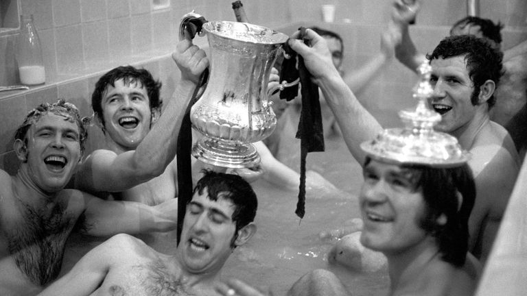 Hollins (second left) and teammates celebrating with the FA Cup