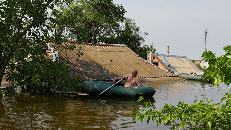 A local resident sits in an inflatable boat in a flooded area following the collapse of the Nova Kakhovka dam in the course of Russia-Ukraine conflict, in the town of Hola Prystan in the Kherson region, Russian-controlled Ukraine, June 8, 2023. REUTERS/Alexander Ermochenko