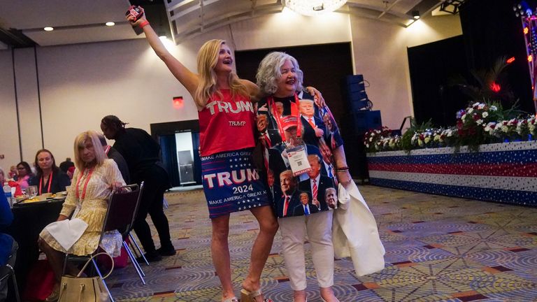 Supporters of former President Donald Trump walk near the stage at the Georgia Republican convention. Pic: AP