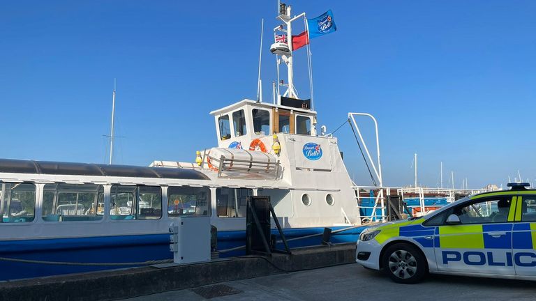 Police are standing by a pleasure boat called the Dorset Belle which is moored in Poole Harbour. 