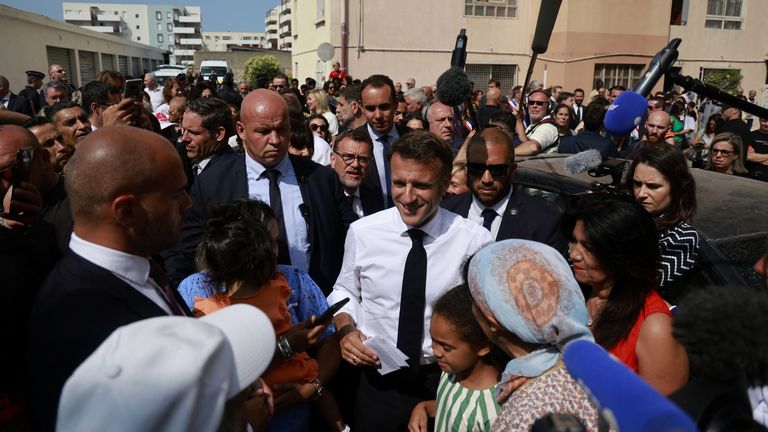 French President Emmanuel Macron meets with residents as he visits the Benza district in Marseille 