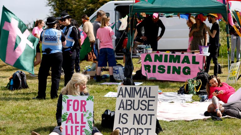 Horse Racing - Epsom Derby Festival - Epsom Downs Racecourse, Epsom, Britain - June 3, 2023 Animal Rising activists display signs to protest before the start of the Epsom Derby Festival Action Images via Reuters/Peter Cziborra