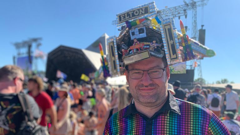 Festivalgoer Alex McGuire wearing an Elton John Pyramid Stage hat at the Glastonbury Festival