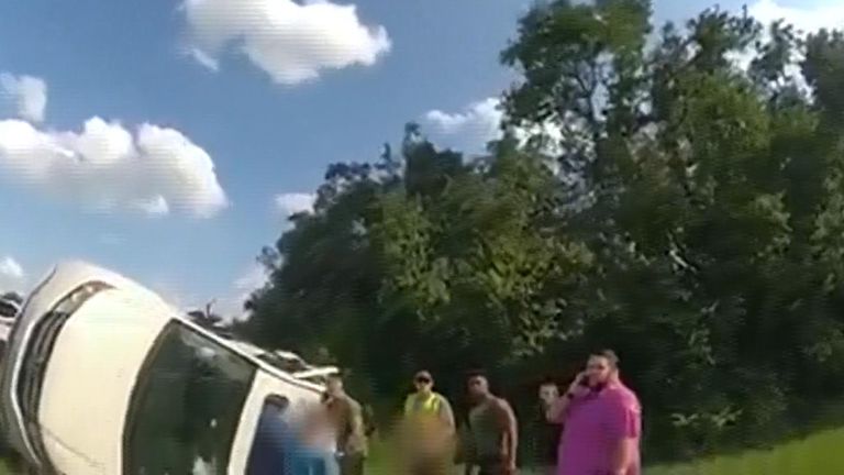 Dramatic police bodycam footage shows a family, including five young children, being rescued following a roll-over accident in Hillsborough County, Florida. Officers and eye witnesses nearby helped rescue the passengers and support the vehicle as the remaining children were saved. 