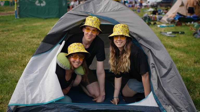 (left to right) Nora Uotila, from Finland, Simon Siegmund and Victoria Pazos in their tent on the first day of the Glastonbury Festival at Worthy Farm in Somerset. Picture date: Wednesday June 21, 2023.