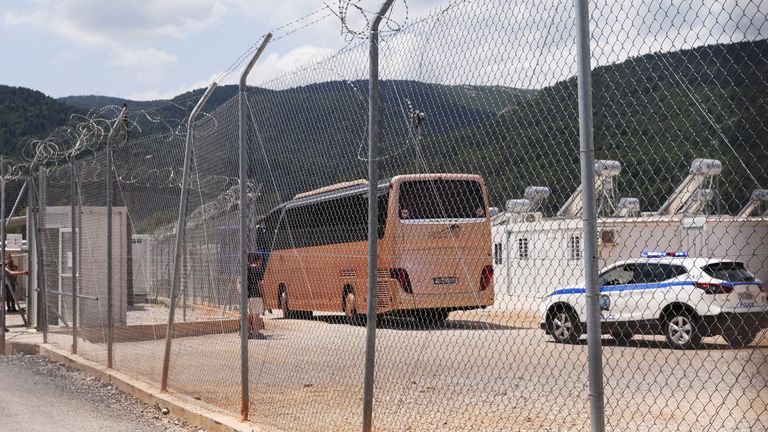 A bus of survivors enters a migrant camp in Malakasa, central Greece on Friday