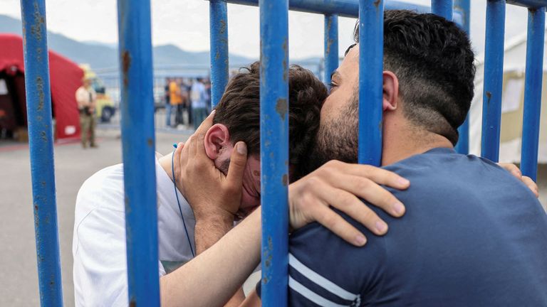 Syrian survivor Mohammad, 18, who was rescued with other refugees and migrants at open sea off Greece after their boat capsized, hugs his brother Fadi, who came to meet him from Netherlands, as they reunite at the port of Kalamata, Greece, June 16, 2023. REUTERS/Stelios Misinas REFILE - CORRECTING IDs