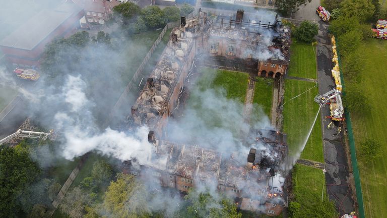 Handout still dated 08/06/2023, from drone footage issued by Tyne and Wear Fire and Rescue Service (TWFRS) of a major blaze at Henderson Old Hall in Heaton, Newcastle. A man has been arrested on suspicion of arson following the fire at the grade II-listed building on Thursday. The blaze destroyed a large section of the roof of the disused building which had previously been Newcastle University student accommodation. Issue date: Friday June 9, 2023.