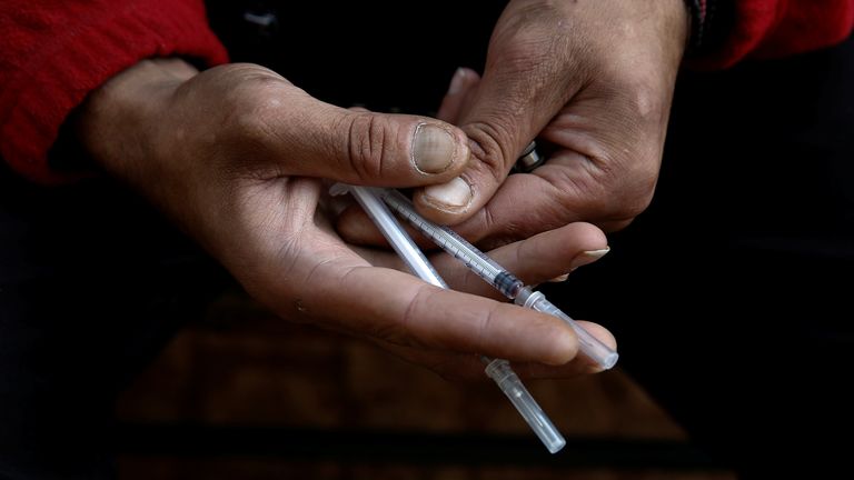 FILE PIC A heroin addict, who didn&#39;t want to be identified, displays needles used for shooting heroin near the Law School building at the University of Athens, Greece, October 24, 2018. REUTERS/Costas Baltas