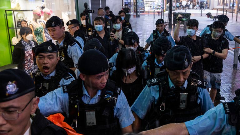 Police officers take away a member of the public in the Causeway Bay area on the eve 34th anniversary of China&#39;s Tiananmen Square massacre in Hong Kong, Saturday, June 3, 2023. (AP Photo/Louise Delmotte)